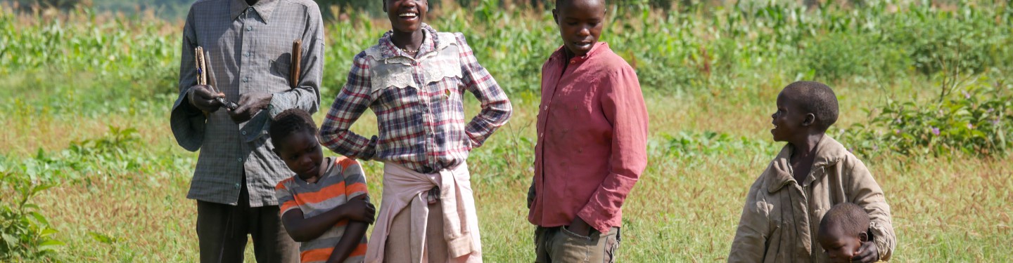 A group of people standing on a field in Africa