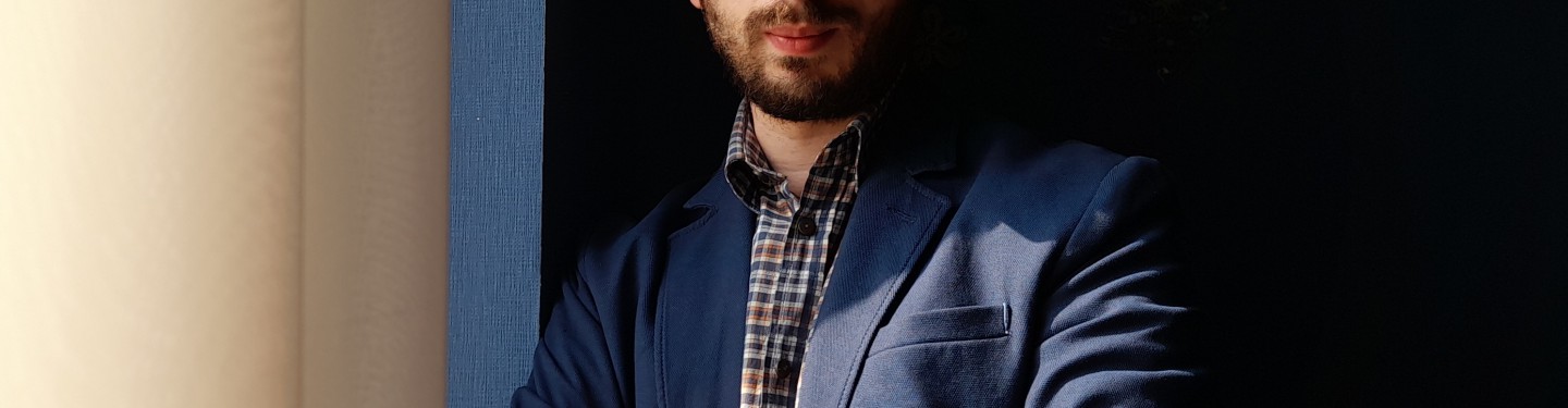 A young man leaning against a wall