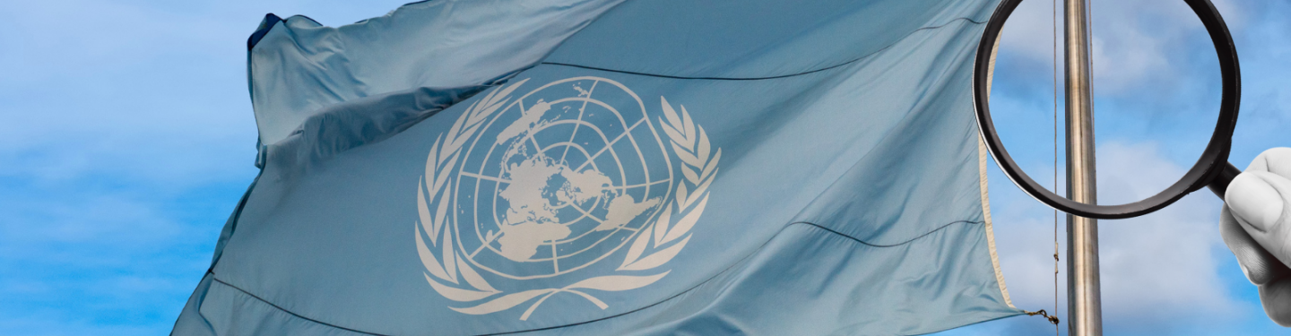 Magnifying glass in front of UN flag