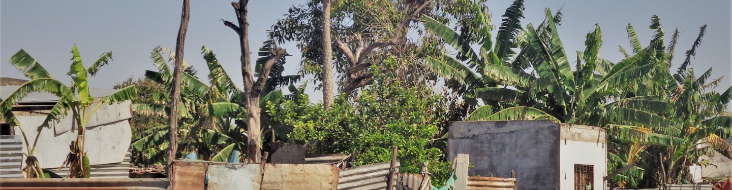 Two women sitting in front of their house in Mozambique