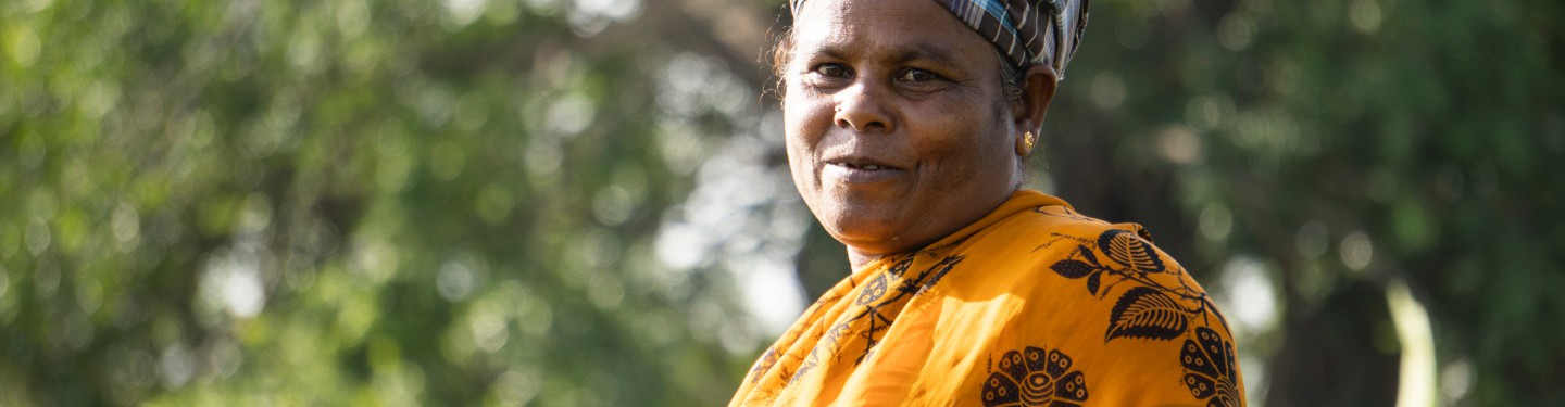 Woman with a smile on her face standing on the fields