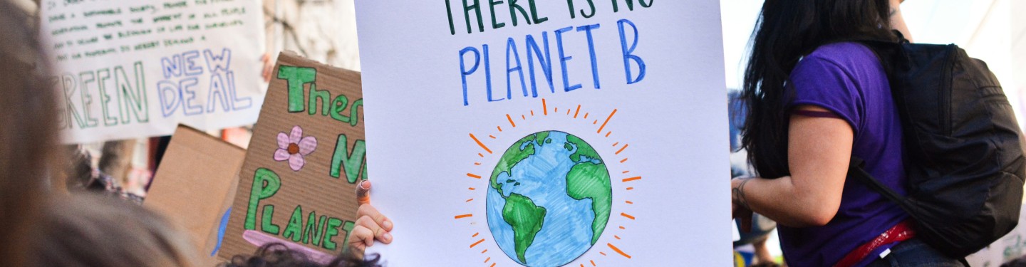 Person holding up there is no planet B poster