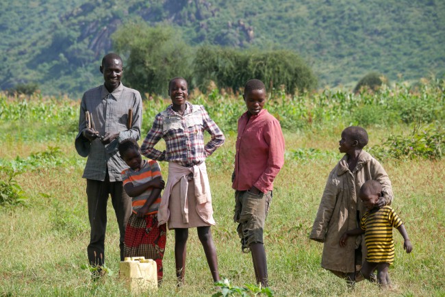 A group of people standing on a field in Africa