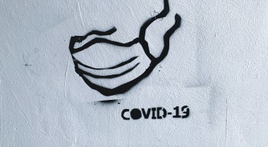 COVID mask painted on a wall 