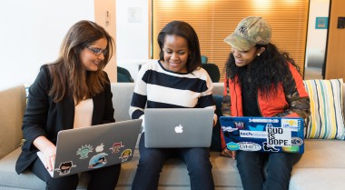 Three young women sitting in front of their laptops