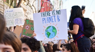 Person holding up there is no planet B poster